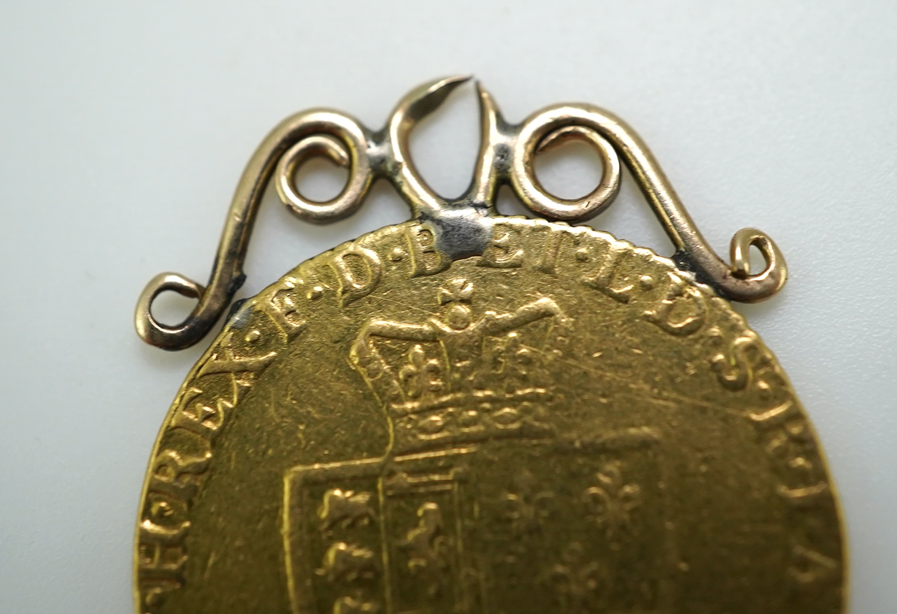 Three George III gold spade guinea coin pendants, late 18th/early 19th century and later